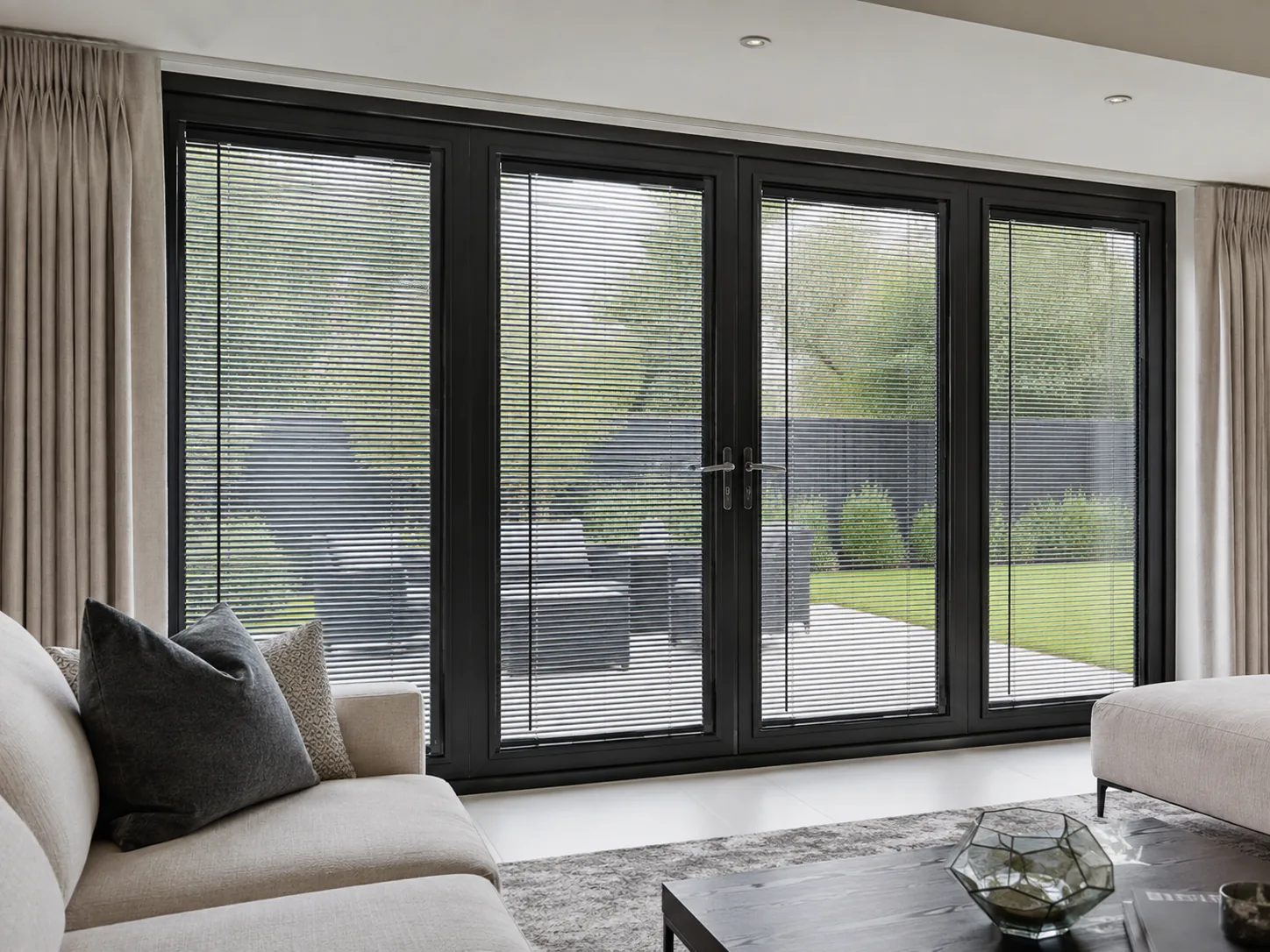 Dark Venetian Blinds fitted across black-framed patio doors.