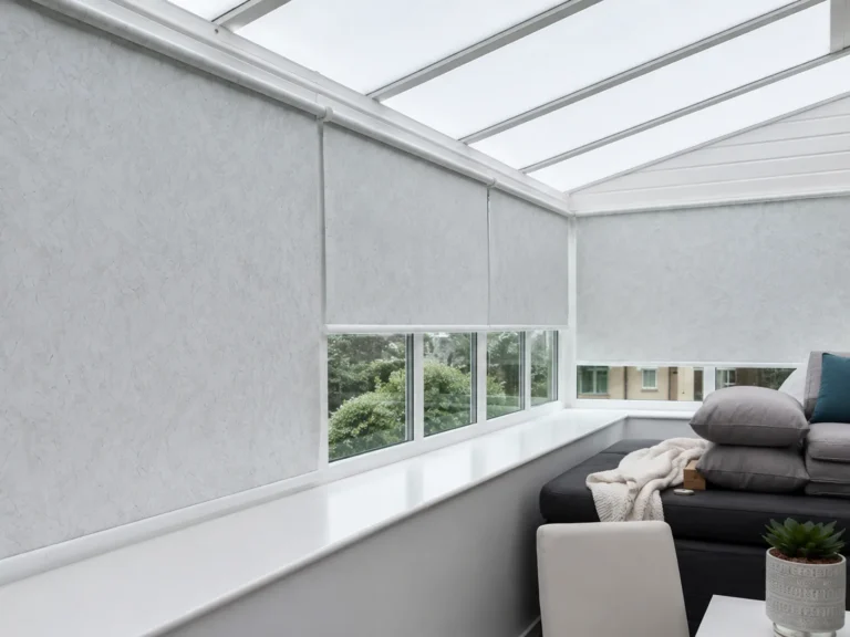 Light roller blinds fitted around a bright conservatory.