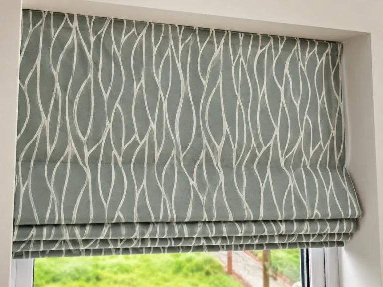 Close view of a patterned Roman blind fitted inside a window recess.